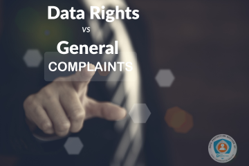  A man's hand, seen from the side, reaches forward with his index finger extended, seemingly to touch a floating, transparent button with the word "COMPLAINTS" on it. Above the button, in large white text, are the words "Data Rights" and "vs General." The background is a blurry, dark office setting with faint hexagonal shapes overlaid on it. In the bottom right corner is a logo for "Data Protection Officer."